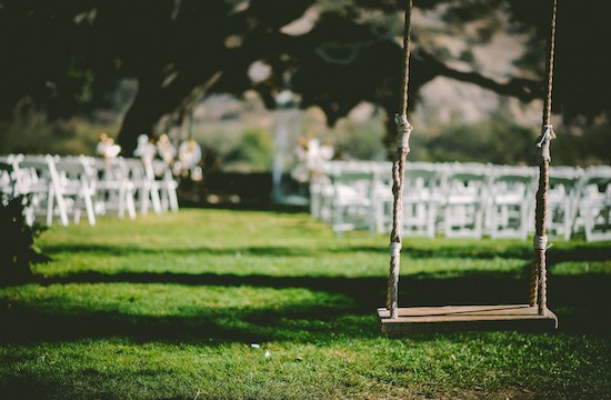 Outdoor wedding scene with swing